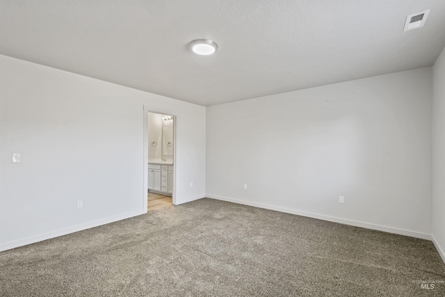 empty room with light carpet, visible vents, and baseboards