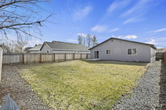 rear view of property with central AC unit, a lawn, and a fenced backyard