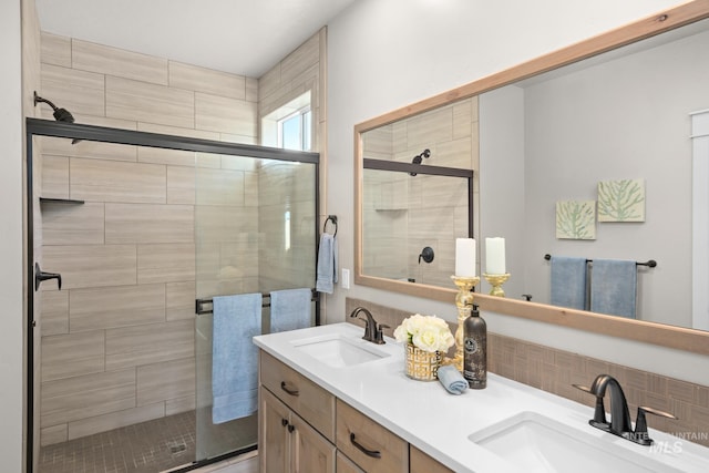 bathroom featuring vanity and a shower with shower door