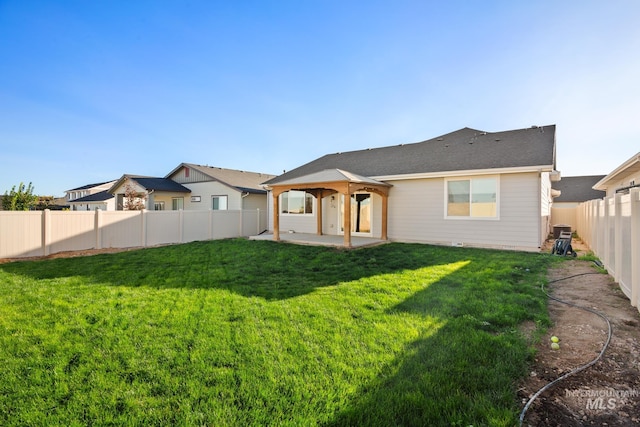 rear view of house featuring a lawn and a patio area