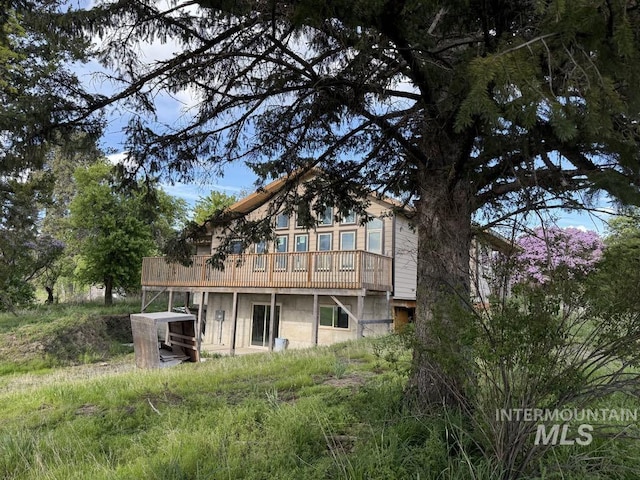 back of property featuring a deck
