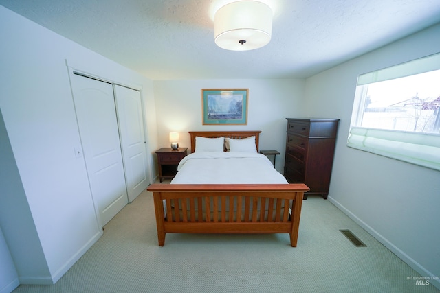 506 Fair Ln, Nampa, ID 83686 - bedroom with visible vents, baseboards, light carpet, a closet, and a textured ceiling