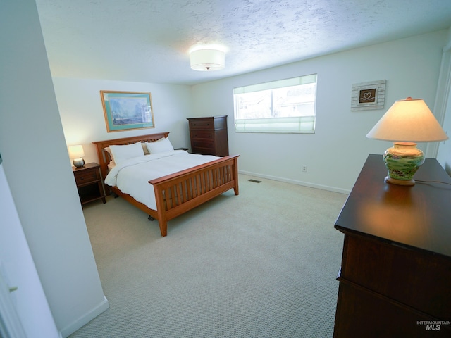 506 Fair Ln, Nampa, ID 83686 - bedroom featuring a textured ceiling, visible vents, baseboards, and light carpet