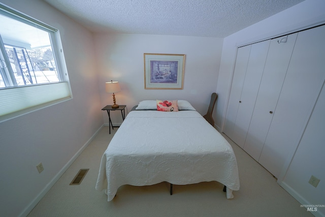 506 Fair Ln, Nampa, ID 83686 - bedroom featuring visible vents, a textured ceiling, a closet, carpet floors, and baseboards