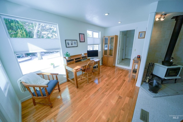 506 Fair Ln, Nampa, ID 83686 - home office featuring visible vents, light wood-style flooring, recessed lighting, baseboards, and a wood stove