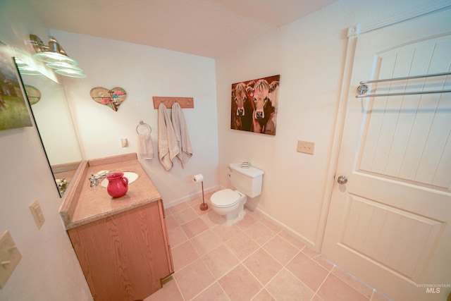 506 Fair Ln, Nampa, ID 83686 - bathroom featuring baseboards, toilet, vanity, and tile patterned flooring