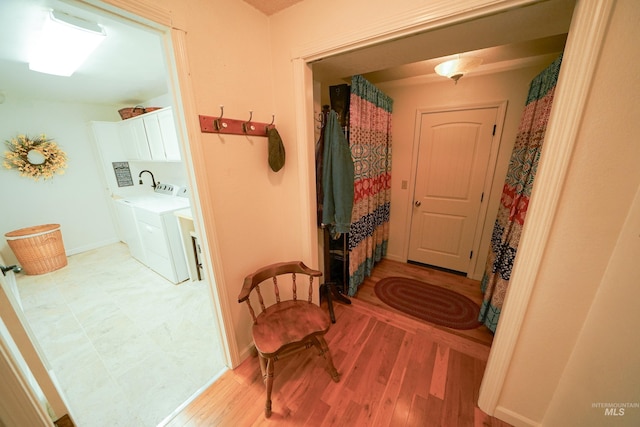 506 Fair Ln, Nampa, ID 83686 - hallway with baseboards, light wood-style floors, and separate washer and dryer