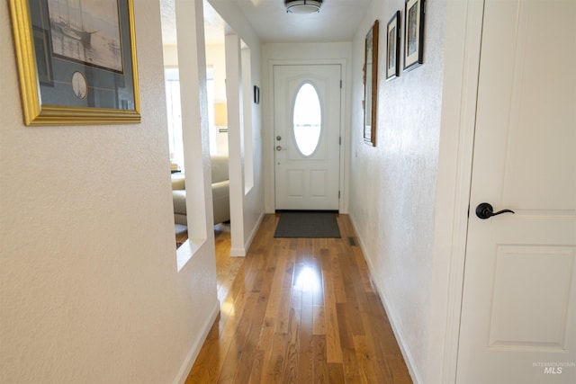 506 Fair Ln, Nampa, ID 83686 - doorway with hardwood / wood-style floors, a textured wall, and baseboards