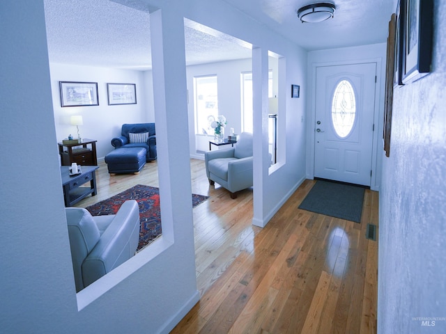 506 Fair Ln, Nampa, ID 83686 - entrance foyer with hardwood / wood-style flooring, baseboards, visible vents, and a textured ceiling