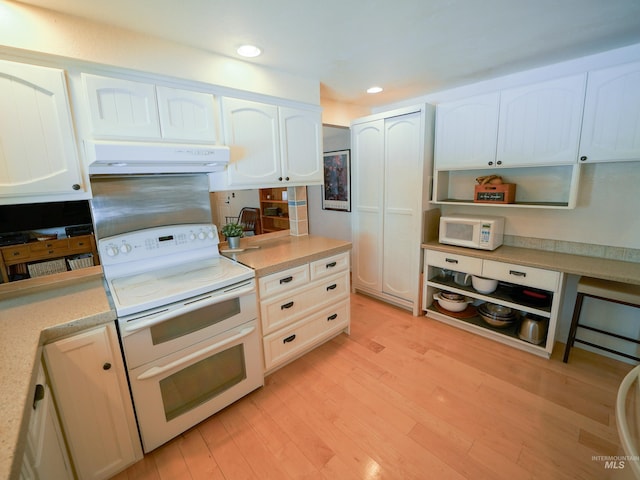 506 Fair Ln, Nampa, ID 83686 - kitchen featuring white appliances, white cabinets, light wood-style floors, and under cabinet range hood