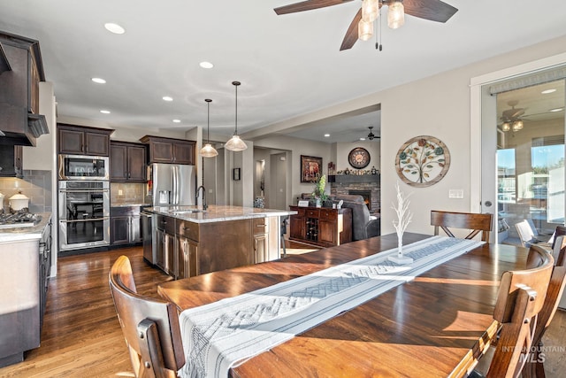 dining area featuring a fireplace and wood-type flooring