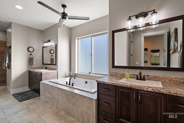 bathroom featuring ceiling fan, a relaxing tiled tub, vanity, and tile patterned flooring