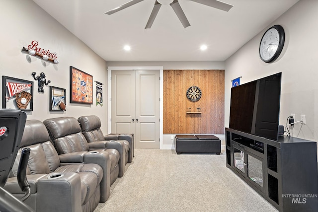 cinema room featuring ceiling fan and light colored carpet