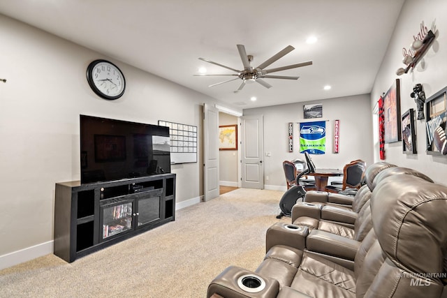 living room with ceiling fan and carpet