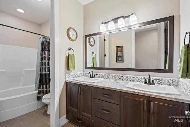 full bathroom with tile patterned floors, vanity, toilet, and shower / bath combination with curtain