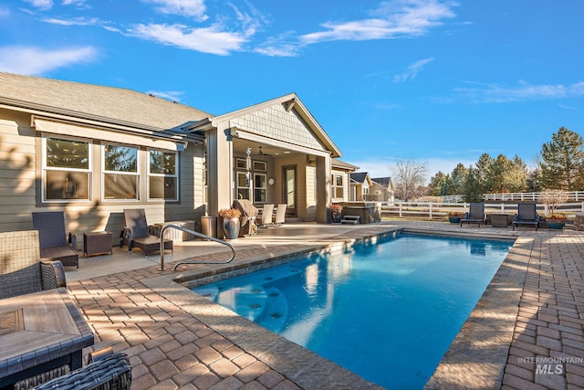 view of pool featuring a patio area, a hot tub, and ceiling fan