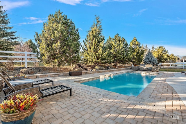 view of swimming pool featuring a patio area