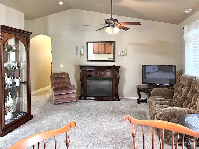 living room featuring carpet flooring, ceiling fan, and lofted ceiling