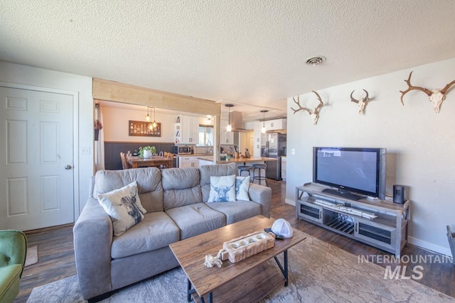 3132 8th St Unit C, Lewiston, ID 83501 - living room featuring wood finished floors and a textured ceiling