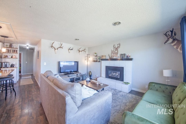 3132 8th St Unit C, Lewiston, ID 83501 - living room with wood finished floors, a textured ceiling, and a fireplace