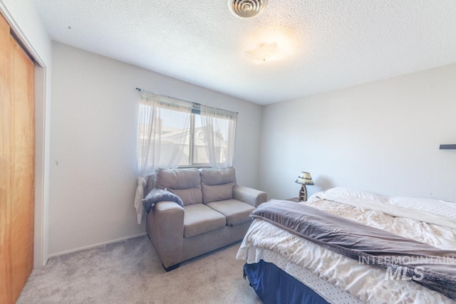 3132 8th St Unit C, Lewiston, ID 83501 - bedroom featuring a closet, carpet floors, and a textured ceiling