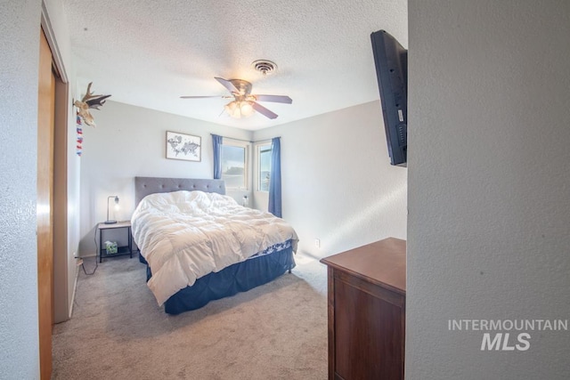 3132 8th St Unit C, Lewiston, ID 83501 - carpeted bedroom with a textured wall, a textured ceiling, and a ceiling fan