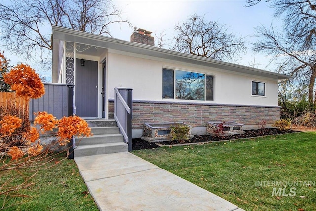 ranch-style home with a front lawn