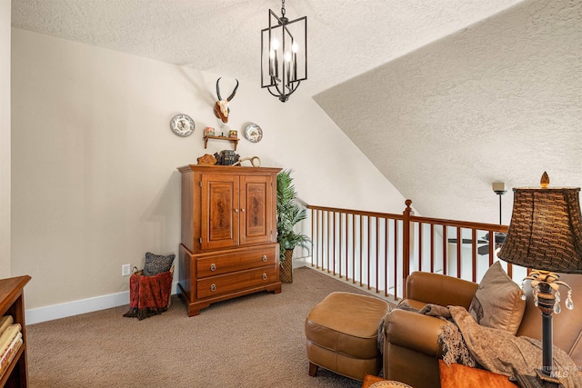 living area with carpet flooring, lofted ceiling, a textured ceiling, and a chandelier