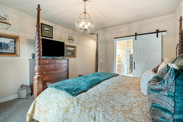 carpeted bedroom featuring a notable chandelier, a barn door, and connected bathroom