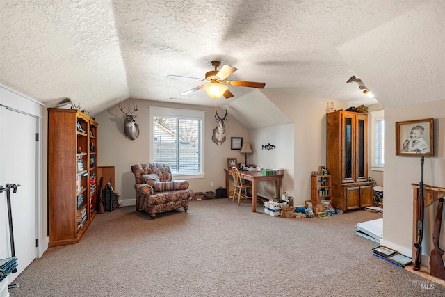 sitting room featuring a textured ceiling, carpet floors, vaulted ceiling, and ceiling fan