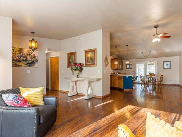 living room with dark hardwood / wood-style floors and ceiling fan