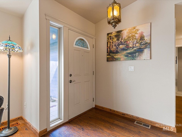 entryway with dark wood-type flooring