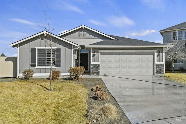 view of front of property featuring a garage, driveway, stone siding, roof with shingles, and board and batten siding