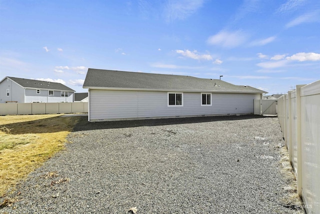 rear view of house with a fenced backyard