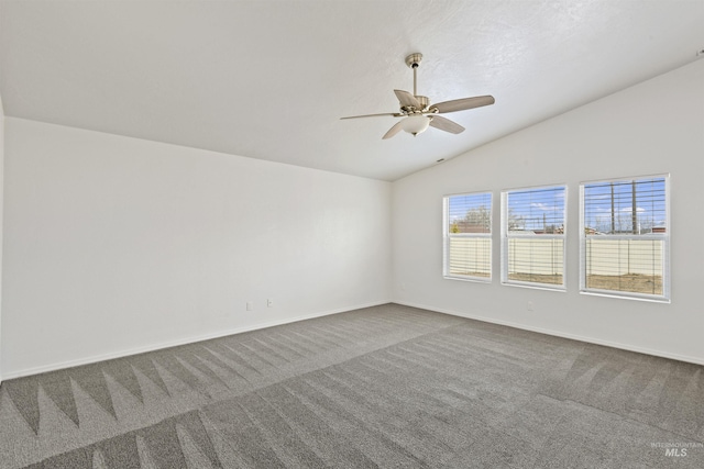 unfurnished room featuring vaulted ceiling, carpet floors, ceiling fan, and baseboards