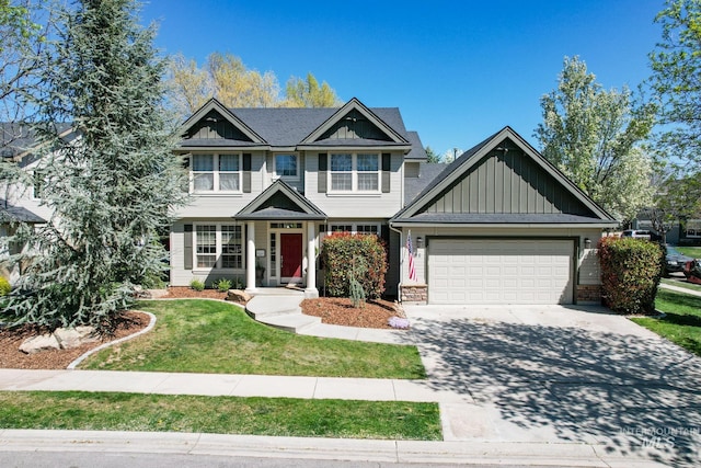 craftsman inspired home with a garage, board and batten siding, driveway, and a front lawn