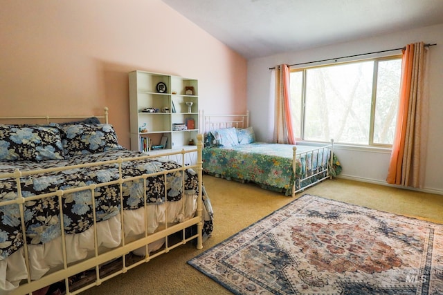 carpeted bedroom with vaulted ceiling