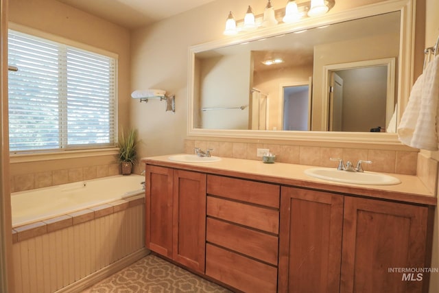full bathroom with double vanity, a sink, and a garden tub