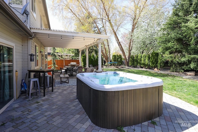 view of patio / terrace with fence, a pergola, outdoor dining area, and a hot tub