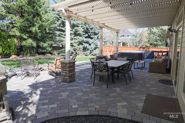 view of patio featuring fence, outdoor dining space, a hot tub, and a pergola