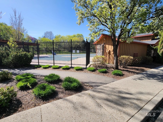 exterior space featuring a community pool and fence