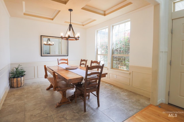dining room featuring a decorative wall, a chandelier, visible vents, ornamental molding, and coffered ceiling