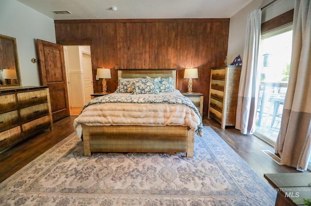 bedroom with multiple windows, dark wood-style flooring, and visible vents