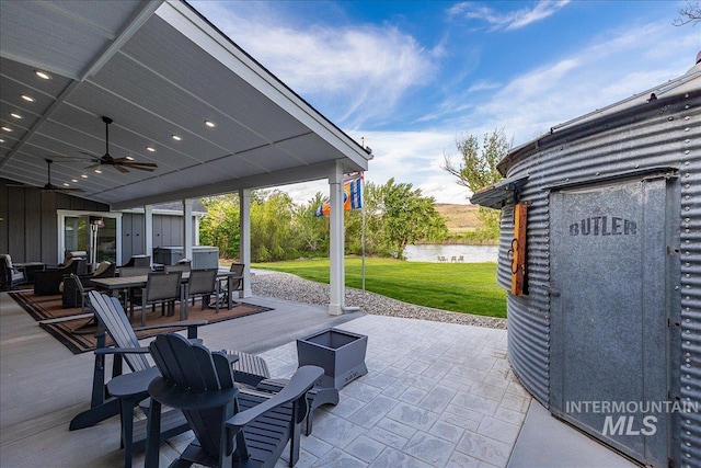 3800 Birch Ln, Emmett, ID 83617 - view of patio / terrace with outdoor dining space, a water view, a ceiling fan, and an outdoor fire pit