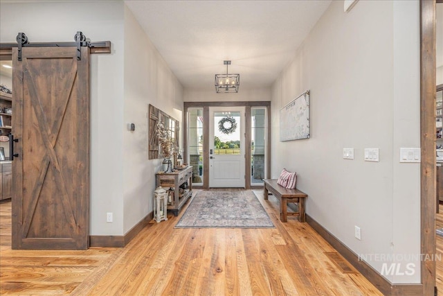 3800 Birch Ln, Emmett, ID 83617 - entryway with light wood-style flooring, baseboards, and a chandelier