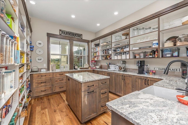 3800 Birch Ln, Emmett, ID 83617 - kitchen with open shelves, a sink, brown cabinets, light stone counters, and recessed lighting