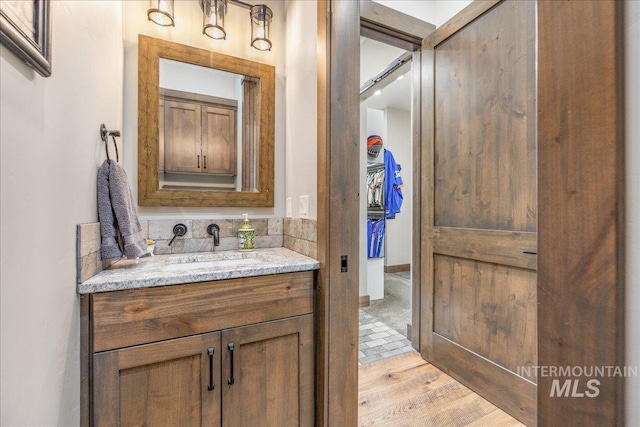 3800 Birch Ln, Emmett, ID 83617 - bathroom with vanity, wood finished floors, and a walk in closet