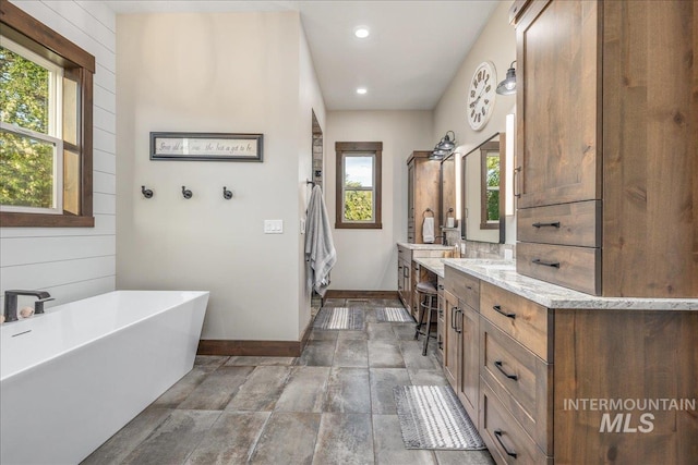 3800 Birch Ln, Emmett, ID 83617 - full bathroom with healthy amount of natural light, vanity, a soaking tub, baseboards, and recessed lighting