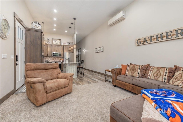 3800 Birch Ln, Emmett, ID 83617 - living room with a wall unit AC, baseboards, light wood-type flooring, recessed lighting, and light colored carpet
