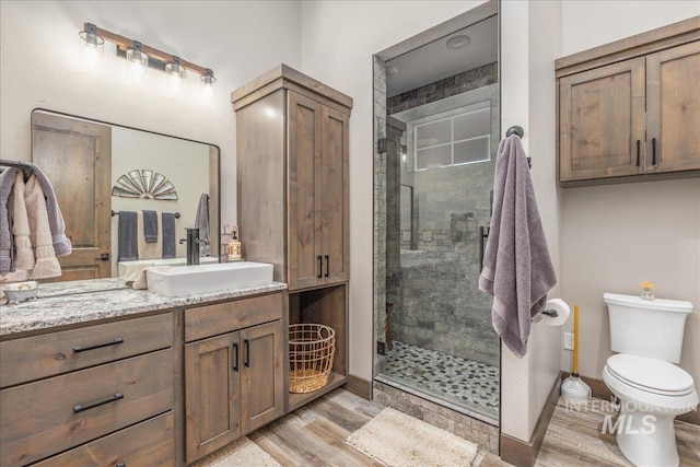 3800 Birch Ln, Emmett, ID 83617 - full bath featuring vanity, a shower stall, wood finished floors, and toilet